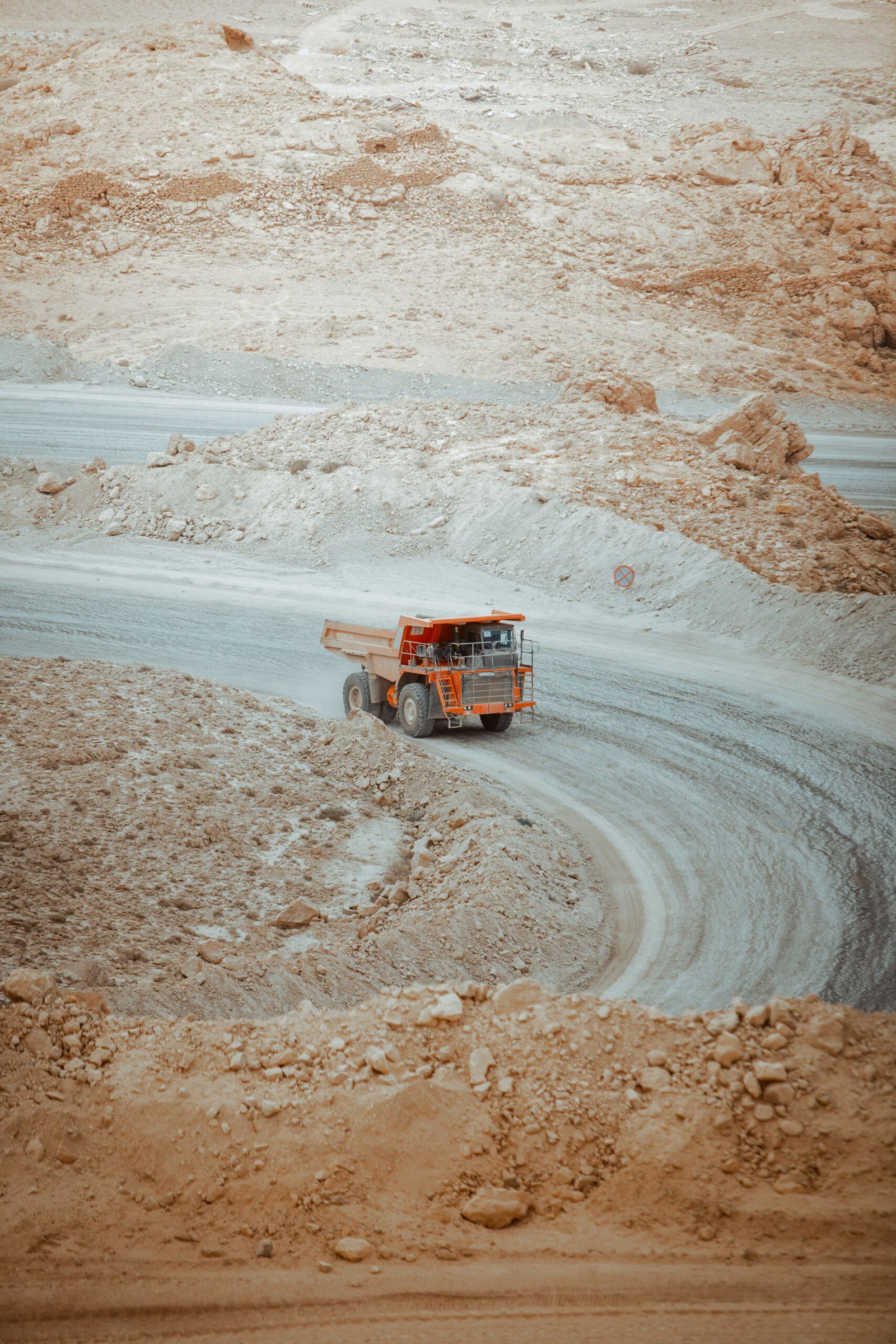 Home courtesy of radwan menzer a heavy dump truck navigates a winding dirt road