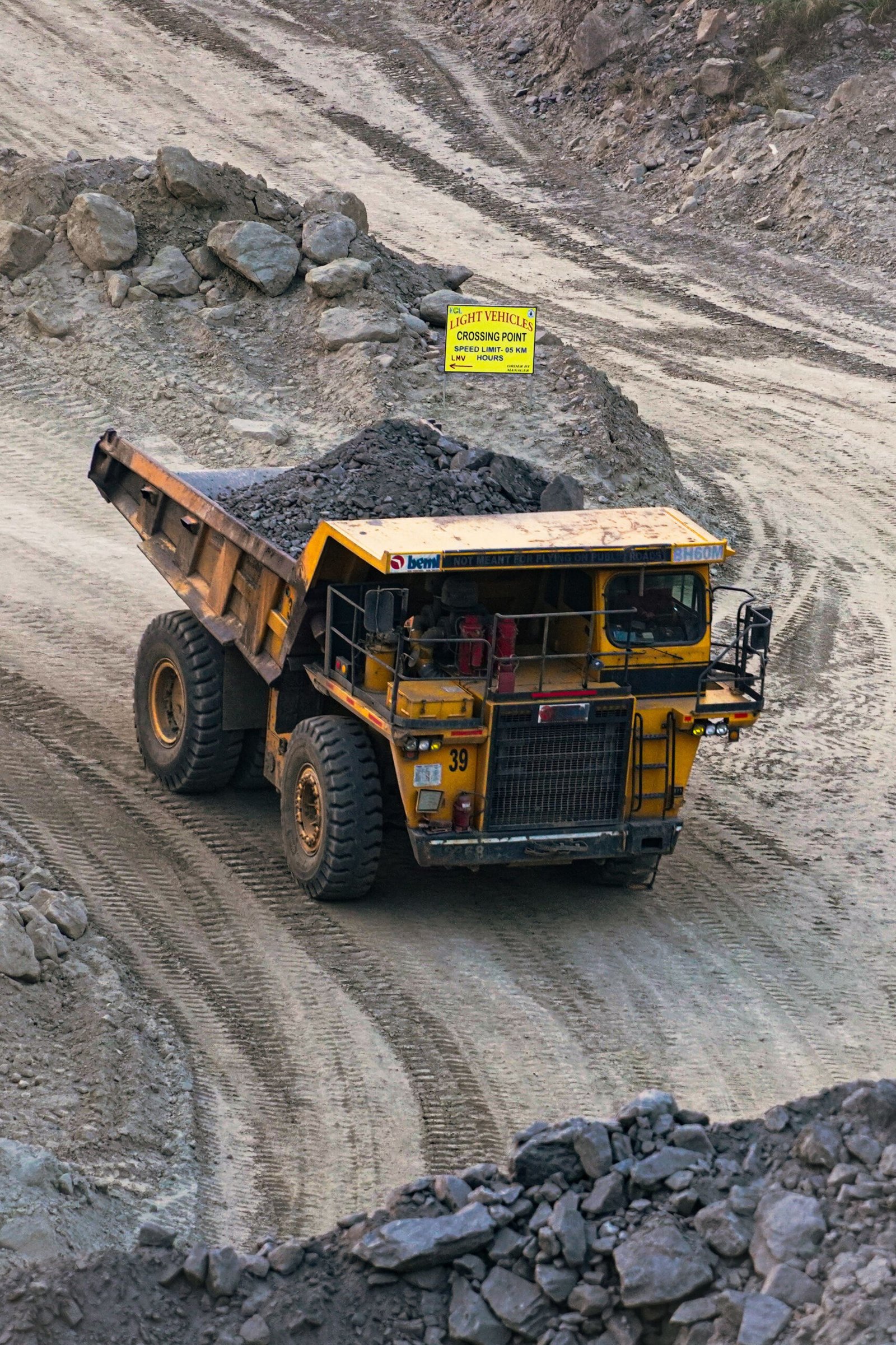 Home courtesy of rounak kayal heavy mining truck transporting minerals in a rocky open pit